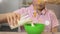 Schoolboy pouring milk in bowl with cereal, tasty healthy breakfast, close up