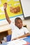 Schoolboy Raising Hand In Classroom