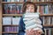 Schoolboy read books, Cute boy reading book in library