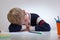 Schoolboy sleeping at the desk