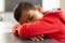 Schoolboy sleeping at desk in a classroom