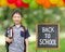 Schoolboy smiles with chalkboard