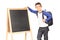Schoolboy standing by a blackboard