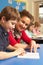 Schoolboy Studying In Classroom With Teacher