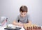 Schoolboy studying homework math during his online lesson at home