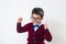 Schoolboy in a sweater and glasses rejoices. Happy child. Conceptual. Copy space