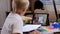 Schoolboy with tablet having video conference chat with teacher.