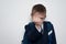 Schoolboy threatens with his fist. Boy in school uniform. White background. Brawler