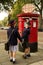 Schoolboy turning while posting letter with sister