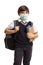 Schoolboy in a uniform with books and backpack wearing a protective face mask