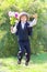 Schoolboy in uniform with a bouquet jumps