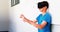 Schoolboy using virtual reality headset in corridor