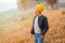 Schoolboy walking in the autumn park. Stylish kid wears jacket, sweater and pants. Autumn fashion, lifestyle