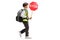 Schoolboy wearing a safety vest and a stop sign and walking