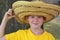 Schoolboy wears a big mexican straw hat