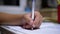 Schoolboy Writes with Left Hand in Notebook, Using Handle. Online Home Training