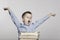 Schoolboy is yawning at the table with books, toning