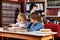 Schoolboys Reading Book Together In Library