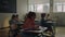 Schoolboys and schoolgirls studying in school room. Pupils sitting at desks