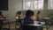 Schoolboys and schoolgirls studying in school room. Pupils sitting at desks