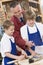 Schoolboys and teacher in woodwork class