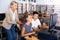 Schoolboys using computer and teacher helping to him in classroom