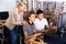 Schoolboys using computer and teacher helping to him in classroom