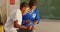 Schoolboys using a smartphone during a break at a township school 4k