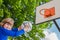 Schoolchild aiming ball at board with basket