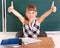 Schoolchild in classroom near blackboard.