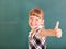 Schoolchild in classroom near blackboard.