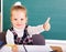 Schoolchild in classroom near blackboard.