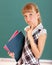 Schoolchild in classroom near blackboard.