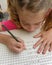 Schoolchild, girl writening math homework