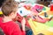 Schoolchild making toy from plasticine