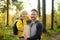 Schoolchild and mature father hiking together and exploring nature. Boy with dad spend quality family time together in sunny