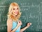 Schoolchild writing on blackboard.