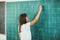 Schoolchild writing on blackboard