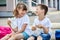 Schoolchildren boy and girl laugh and eat their lunch, snack, breakfast in the school yard. Food for children in educational