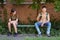 Schoolchildren a boy and a teenage girl are sitting on a bench outside the school building