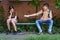 Schoolchildren a boy and a teenage girl are sitting on a bench outside the school building, the boy gives a protective breathing