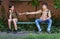 schoolchildren a boy and a teenage girl are sitting on a bench outside the school building, the boy gives a protective breathing m