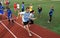 Schoolchildren in the classroom, running, relay race with a stick