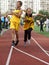 Schoolchildren in the classroom, running, relay race with a stick. Physical education lesson at a Moscow school