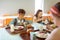 Schoolchildren having yummy lunch in canteen together