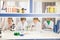 Schoolchildren in lab coats studying together