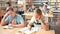 Schoolchildren preparing for lesson in school library, reading textbooks