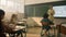 Schoolchildren sitting at desks in classroom. Schoolteacher teaching students