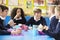 Schoolchildren Sitting At Table Eating Packed Lunch