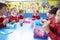 Schoolchildren Sitting At Table Eating Packed Lunch